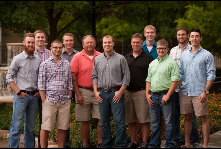 Men standing together on a golf course